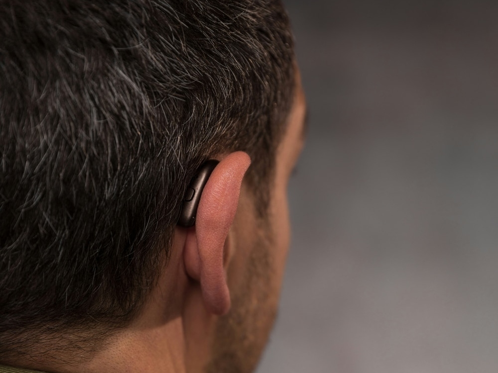 Doctor of Audiology programming a new hearing aid during a fitting at Hughes Holistic Audiology in Zionsville, IN