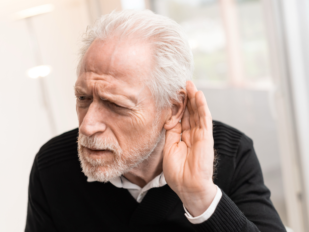 Patient learning about sensorineural, conductive, and mixed types of hearing loss at Hughes Holistic Audiology in Zionsville, IN