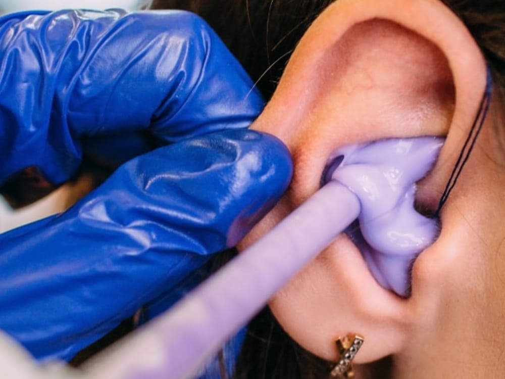 Doctor of Audiology taking a custom ear impression for hearing protection at Hughes Holistic Audiology in Zionsville, IN